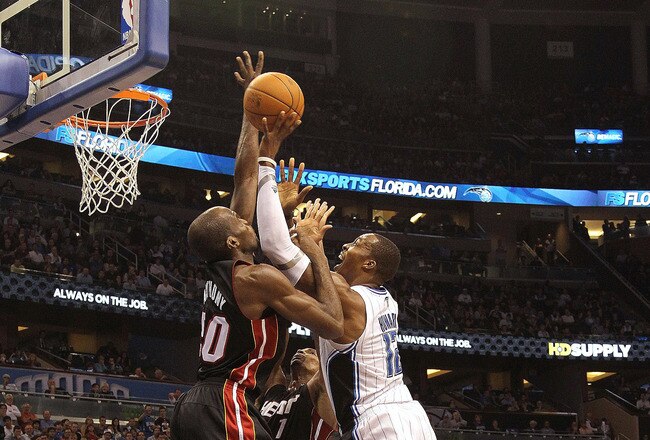 ORLANDO, FL - NOVEMBER 24:  Dwight Howard #12 of the Orlando Magic shoots over Joel Anthony #50 of the Miami Heat during a game at Amway Arena on November 24, 2010 in Orlando, Florida. NOTE TO USER: User expressly acknowledges and agrees that, by downloading and/or using this Photograph, User is consenting to the terms and conditions of the Getty Images License Agreement.  (Photo by Mike Ehrmann/Getty Images)
