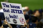 NEW YORK - NOVEMBER 04:  A fan of the New York Yankees holds up a sign which reads 'The House that Jeter built' in reference to Derek Jeter #2 of the Yankees against the Philadelphia Phillies in Game Six of the 2009 MLB World Series at Yankee Stadium on November 4, 2009 in the Bronx borough of New York City.  (Photo by Chris McGrath/Getty Images)