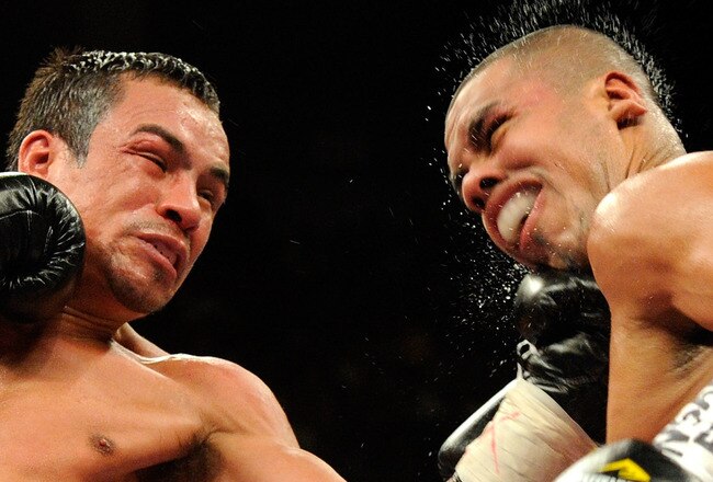 LAS VEGAS - JULY 31:  WBA/WBO lightweight champion Juan Manuel Marquez (L) hits Juan Diaz in the fourth round of their bout at the Mandalay Bay Events Center July 31, 2010 in Las Vegas, Nevada. Marquez retained his WBA and WBO lightweight championship belts with a unanimous-decision victory over Diaz.  (Photo by Ethan Miller/Getty Images)
