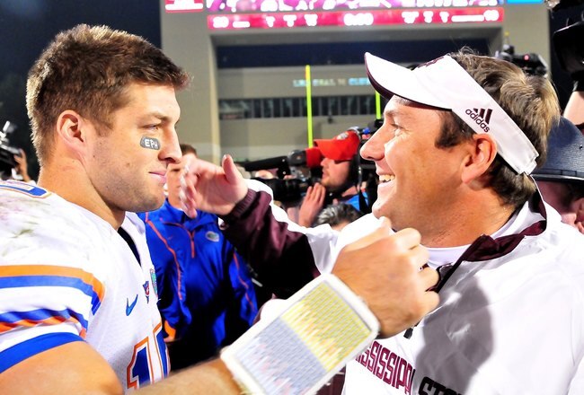 STARKVILLE, MS - OCTOBER 24:  Quarterback Tim Tebow # 15 of the Florida Gators and Mississippi State Bulldogs head coach Dan Mullen greet one another following the game, at Davis Wade Stadium on  October 24, 2009 in Starkville, Mississippi  (Photo by Rick Dole/Getty Images)