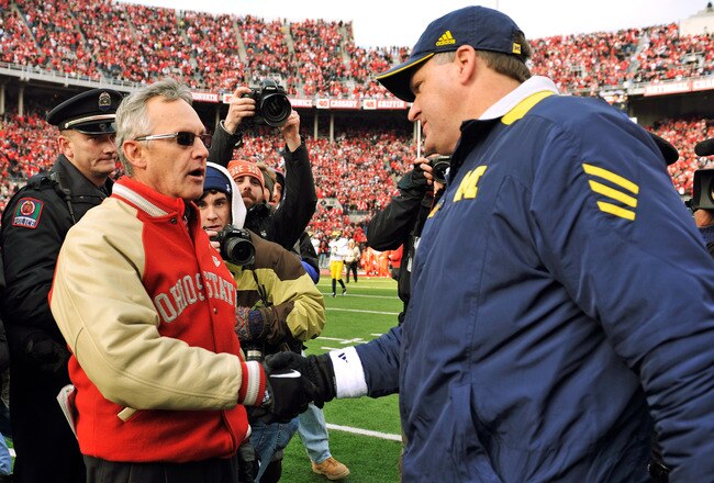 COLUMBUS, OH - NOVEMBER 27:  Head Coach Jim Tressel of the Ohio State Buckeyes shakes hands with Head Coach Rich Rodriguez after the Buckeyes defeated the Wolverines 37-7 at Ohio Stadium on November 27, 2010 in Columbus, Ohio.  (Photo by Jamie Sabau/Getty Images)