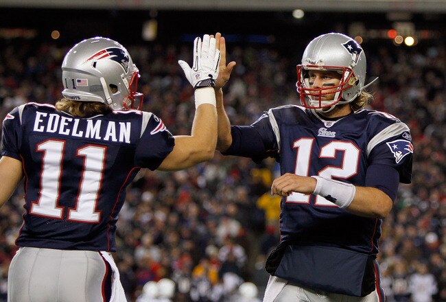 FOXBORO, MA - NOVEMBER 21: Tom Brady #12 of the New England Patriots reacts with teammate Julian Edelman #11 after a touchdown in the second half at Gillette Stadium on November 21, 2010 in Foxboro, Massachusetts. (Photo by Jim Rogash/Getty Images)
