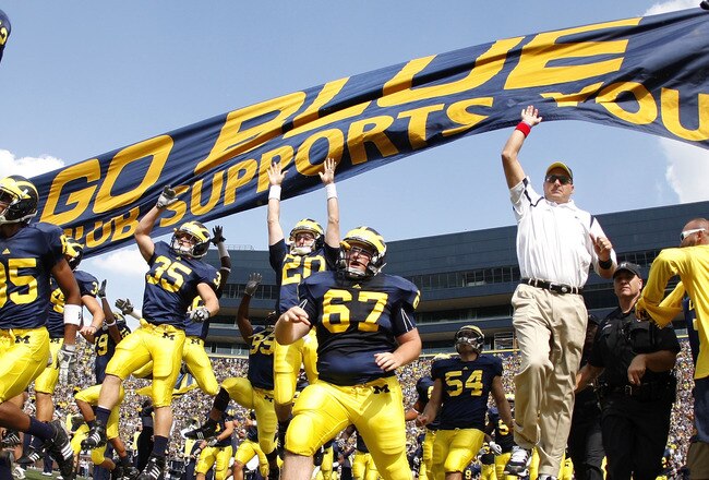 ANN ARBOR, MI - SEPTEMBER 05:  Head coach Rich Rodriguez enters the stadium with his team prior to playing the Western Michigan Broncos on September 5, 2009 at Michigan Stadium in Ann Arbor, Michigan.  (Photo by Gregory Shamus/Getty Images)