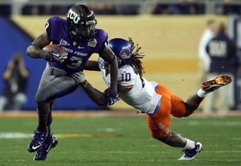 GLENDALE, AZ - JANUARY 04:  Antoine Hicks #13 of the TCU Horned Frogs runs after a catch as he is grabbed by Jerrell Gavins #10 of the Boise State Broncos during the Tostitos Fiesta Bowl at the Universtity of Phoenix Stadium on January 4, 2010 in Glendale, Arizona.  (Photo by Jed Jacobsohn/Getty Images)