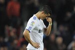 BARCELONA, SPAIN - NOVEMBER 29:  Cristiano Ronaldo of Real Madrid (R) looks down as Eric Abidal and Dani Alves of Barcelona celebrates the fifth goal  against Real Madrid during the La Liga match between Barcelona and Real Madrid at the Camp Nou Stadium on November 29, 2010 in Barcelona, Spain. Bacelona won 5-0.  (Photo by David Ramos/Getty Images)