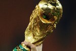 JOHANNESBURG, SOUTH AFRICA - JULY 11:  The  World Cup trophy is held aloft as the Spain team celebrate victory following the 2010 FIFA World Cup South Africa Final match between Netherlands and Spain at Soccer City Stadium on July 11, 2010 in Johannesburg, South Africa.  (Photo by Jasper Juinen/Getty Images)