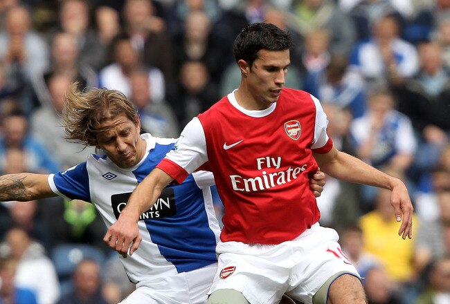BLACKBURN, ENGLAND - AUGUST 28:  Robin van Persie of Arsenal battles for the ball with Michel Salgado of Blackburn Rovers during the Barclays Premier League match between Blackburn Rovers and Arsenal at Ewood Park on August 28, 2010 in Blackburn, England. (Photo by Clive Brunskill/Getty Images)