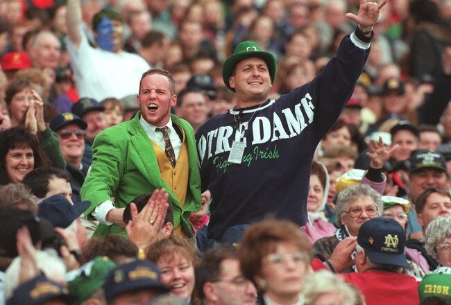 2 Nov 1996:  The University of Notre Dame Leprechaun mascot celebrates with a fan in the crowd during the Fighting Irish 54-27 Shamrock Classic win over Navy in Dublin, Ireland. Mandatory Credit: Billy Stickland/ALLSPORT