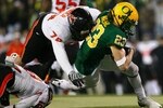 EUGENE,OR - DECEMBER 03:  Brennan Olander #78 of the Oregon State Beavers tackles Jeff Maehl #23 of the Oregon Ducks during the second quarter of the game at Autzen Stadium on December 3, 2009 in Eugene, Oregon.  (Photo by Tom Hauck/Getty Images)