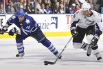 TORONTO, CANADA - NOVEMBER 30:  Mike Brown #18 of the Toronto Maple Leafs skates after Ryan Malone #6 of the Tampa Bay Lightning during game action November 30, 2010 at the Air Canada Centre in Toronto, Ontario, Canada. (Photo by Abelimages/Getty Images)