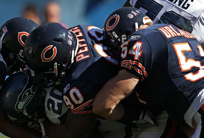 CHICAGO - OCTOBER 17: Justin Forsett #20 of the Seattle Seahawks is tackled by (L-R) Pia Tinoisamoa #59, Julius Peppers #90 and Brian Urlacher #54 of the Chicago Bears at Soldier Field on October 17, 2010 in Chicago, Illinois. The Seahawks defeated the Bears 23-20. (Photo by Jonathan Daniel/Getty Images)