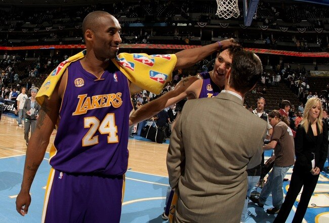 DENVER - APRIL 26:  Kobe Bryant #24 of the Los Angeles Lakers interupts a television interview with teammate Luke Walton #4 after they defeated the Denver Nuggets in Game Three of the Western Conference Quarterfinals during the 2008 NBA Playoffs at the Pepsi Center on April 26, 2008 in Denver, Colorado. The Lakers defeated the Nuggets 102-84 to take a 3-0 series lead. NOTE TO USER: User expressly acknowledges and agrees that, by downloading and or using this photograph, user is consenting to the term and conditions of the Getty Images License Agreement.  (Photo by Doug Pensinger/Getty Images)