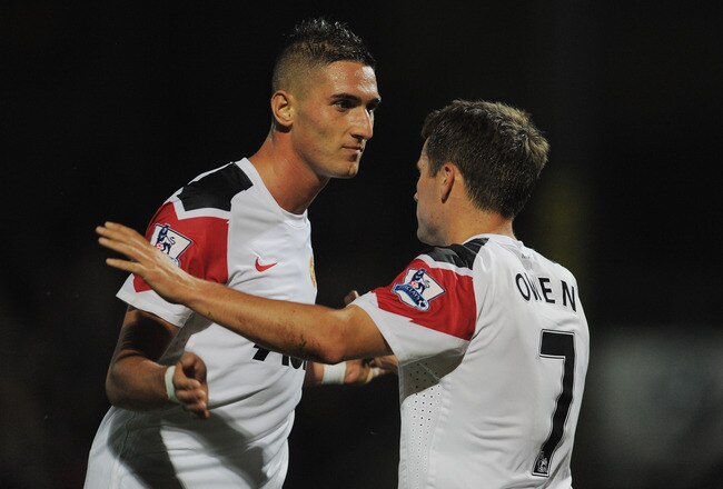 SCUNTHORPE, ENGLAND - SEPTEMBER 22: Federico Macheda of Manchester United congratulates team mate Michael Owen after his goal to make it to make it 5-1 during the Carling Cup 3rd Round match between Scunthorpe United and Manchester United at Glanford Park on September 22, 2010 in Scunthorpe, England.  (Photo by Michael Regan/Getty Images)