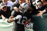 OAKLAND, CA - NOVEMBER 28:  Jacoby Ford #12 of the Oakland Raiders is congratulated by fan after he scored a touchdown against the Miami Dolphins at Oakland-Alameda County Coliseum on November 28, 2010 in Oakland, California.  (Photo by Ezra Shaw/Getty Images)