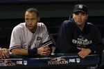 ARLINGTON, TX - OCTOBER 22:  Derek Jeter #2 and Andy Pettitte #46 of the New York Yankees look on from the dugout in Game Six of the ALCS against the Texas Rangers during the 2010 MLB Playoffs at Rangers Ballpark in Arlington on October 22, 2010 in Arlington, Texas.  (Photo by Ronald Martinez/Getty Images)
