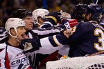 ST. LOUIS, MO - DECEMBER 1: linesman Brian Murphy #93 breaks up a scuffle between Matt Hendricks #26 of the Washington Capitals and Tyson Strachan #33 of the St. Louis Blues at the Scottrade Center on December 1, 2010 in St. Louis, Missouri.  (Photo by Dilip Vishwanat/Getty Images)