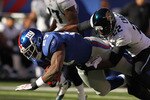 EAST RUTHERFORD, NJ - NOVEMBER 28:  Brandon Jacobs #27 of the New York Giants is tackled by Don Carey #22 of the Jacksonville Jaguars during their game on November 28, 2010 at The New Meadowlands Stadium in East Rutherford, New Jersey.  (Photo by Al Bello/Getty Images)