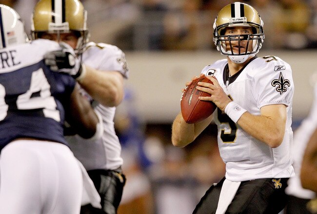 ARLINGTON, TX - NOVEMBER 25:  Quarterback Drew Brees #9 of the New Orleans Saints looks for an open receiver while playing the Dallas Cowboys at Cowboys Stadium on November 25, 2010 in Arlington, Texas.  (Photo by Matthew Stockman/Getty Images)