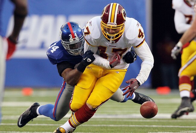 EAST RUTHERFORD, NJ - DECEMBER 05:  Deon Grant #34 of the New York Giants forces a fourth quarter fumble against Chris Cooley #47 of the Washington Redskins on December 5, 2010 at the New Meadowlands Stadium in East Rutherford, New Jersey. The Giants defeated the Redskins 31-7.  (Photo by Jim McIsaac/Getty Images)