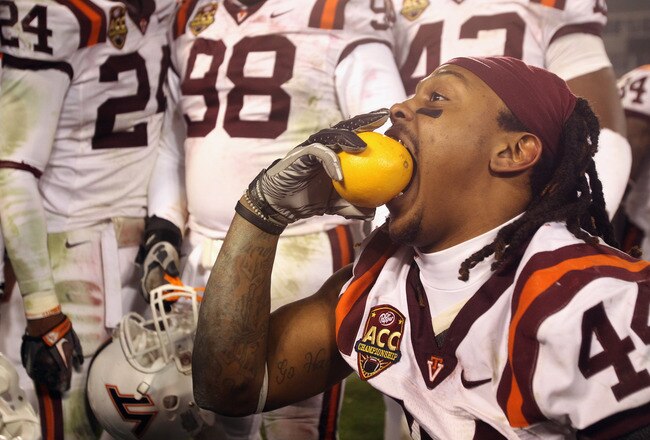 CHARLOTTE, NC - DECEMBER 04:  Lyndell Gibson #44 of the Virginia Tech Hokies celebrates with an orange after defeating the Florida State Seminoles to win the ACC Championship 44-33 at Bank of America Stadium on December 4, 2010 in Charlotte, North Carolina. The Hokies will play in the Orange Bowl. (Photo by Streeter Lecka/Getty Images)