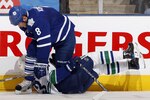 TORONTO - NOVEMBER 13: Mike Komisarek #8 of the Toronto Maple Leafs runs over Alexander Edler #23 of the Vancouver Canucks during game action at the Air Canada Centre November 13, 2010 in Toronto, Ontario, Canada. (Photo by Abelimages / Getty Images)
