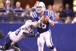 INDIANAPOLIS - NOVEMBER 28:  Peyton Manning #18 of the Indianapolis Colts looks to throw a pass while pursued by Kevin Burnett #99 of the San Diego Chargers during the NFL game at Lucas Oil Stadium on November 28, 2010 in Indianapolis, Indiana.  The Chargers won 36-14.  (Photo by Andy Lyons/Getty Images)