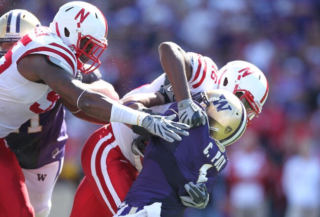 SEATTLE - SEPTEMBER 18: Running back Chris Polk #1 of the Washington Huskies is tackled by linebacker Eric Martin #46 and defensive end Pierre Allen #95 of the Nebraska Cornhuskers on September 18, 2010 at Husky Stadium in Seattle, Washington. (Photo by Otto Greule Jr/Getty Images)