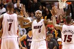 MIAMI, FL - DECEMBER 04:  LeBron James #6 of the Miami Heat is congratulated by Chris Bosh #1 and Mario Chalmers #15 during a game against the Atlanta Hawks at American Airlines Arena on December 4, 2010 in Miami, Florida. NOTE TO USER: User expressly acknowledges and agrees that, by downloading and/or using this Photograph, User is consenting to the terms and conditions of the Getty Images License Agreement.  (Photo by Mike Ehrmann/Getty Images)