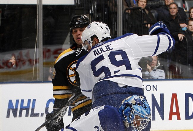 TORONTO, CANADA - DECEMBER 4: Jean-Sebastien Giguere #35 of the Toronto Maple Leafs stops the puck in front of Nathan Horton #18 of the Boston Bruins and Keith Aulie #59 during game action at the Air Canada Centre December 4, 2010 in Toronto, Ontario, Canada. (Photo by Abelimages / Getty Images)