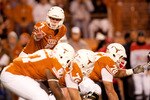 AUSTIN, TX - NOVEMBER 25:  University of Texas quarterback Garrett Gilbert #7 calls a play during the first half against Texas A&M at Darrell K. Royal-Texas Memorial Stadium on November 25, 2010 in Austin, Texas. (Photo by Darren Carroll/Getty Images)