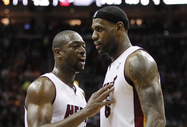 CLEVELAND, OH - DECEMBER 02:  LeBron James #6 of the Miami Heat talks to Dwyane Wade #3 while playing the Cleveland Cavaliers at Quicken Loans Arena on December 2, 2010 in Cleveland, Ohio. NOTE TO USER: User expressly acknowledges and agrees that, by downloading and or using this photograph, User is consenting to the terms and conditions of the Getty Images License Agreement.  (Photo by Gregory Shamus/Getty Images)