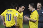 ALMERIA, SPAIN - MARCH 06:  Lionel Messi, Xavi Hernandez and Andres Iniesta (R) of Barcelona talk before Messi scored from a free kick during the La Liga match between UD Almeria and Barcelona at Estadio del Mediterraneo on March 6, 2010 in Almeria, Spain.  (Photo by Denis Doyle/Getty Images)