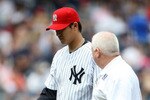 NEW YORK - JULY 04:  Chien-Ming Wang #40 of the New York Yankees leaves the game in the sixth inning with a strained right shoulder against the Toronto Blue Jays on July 4, 2009 at Yankee Stadium in the Bronx borough of New York City.  (Photo by Nick Laham/Getty Images)