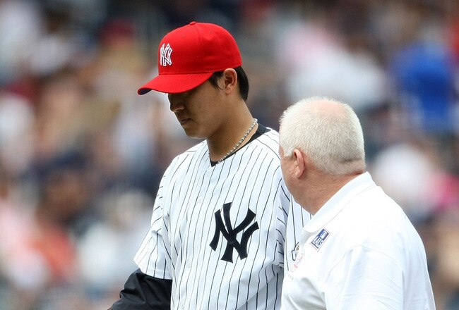 NEW YORK - JULY 04:  Chien-Ming Wang #40 of the New York Yankees leaves the game in the sixth inning with a strained right shoulder against the Toronto Blue Jays on July 4, 2009 at Yankee Stadium in the Bronx borough of New York City.  (Photo by Nick Laham/Getty Images)