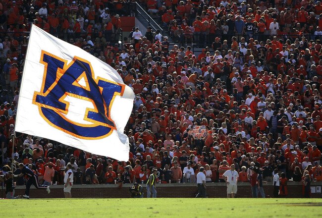 AUBURN - OCTOBER 16:  An Auburn cheerleader runs in the end zone with the Auburn flag after a touchdown during the game between the Arkansas Razorbacks and the Auburn Tigers at Jordan-Hare Stadium on October 16, 2010 in Auburn, Alabama.  (Photo by Mike Zarrilli/Getty Images)