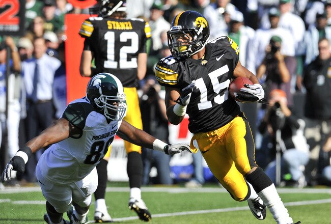 IOWA CITY, IA - OCTOBER 30: Wide reciver Derrell Johnson-Koulianos #15 of the University of Iowa Hawkeyes runs the ball past defensive end Colin Neely #89 of the Michigan State Spartans during the first half of play at Kinnick Stadium on October 30, 2010 in Iowa City, Iowa. Iowa won 37-6 over Michigan State. (Photo by David Purdy/Getty Images)