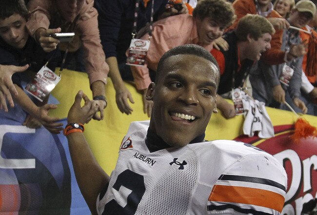 ATLANTA - DECEMBER 04:  Quarterback Cam Newton #2 of the Auburn Tigers celebrates with the crowd after the 2010 SEC Championship against the South Carolina Gamecocks at Georgia Dome on December 4, 2010 in Atlanta, Georgia.  The Tigers beat the Gamecocks 56-17.  (Photo by Mike Zarrilli/Getty Images)