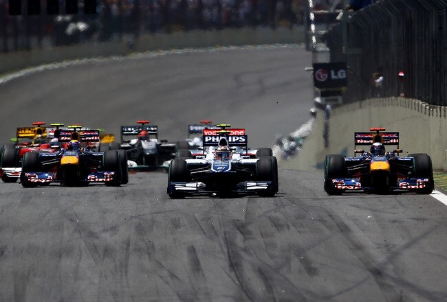SAO PAULO, BRAZIL - NOVEMBER 07:  Sebastian Vettel of Germany and Red Bull Racing and Nico Huelkenberg of Germany and Williams compete after the start during the Brazilian Formula One Grand Prix at the Interlagos Circuit on November 7, 2010 in Sao Paulo, Brazil.  (Photo by Vladimir Rys/Getty Images)
