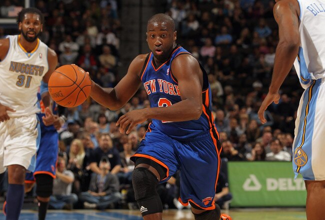 DENVER - NOVEMBER 16:  Raymond Felton #2 of the New York Knicks drives with the ball between Nene #31 and Chauncey Billups #1 of the Denver Nuggets defends at the Pepsi Center on November 16, 2010 in Denver, Colorado. NOTE TO USER: User expressly acknowledges and agrees that, by downloading and/or using this Photograph, User is consenting to the terms and conditions of the Getty Images License Agreement.  (Photo by Doug Pensinger/Getty Images)