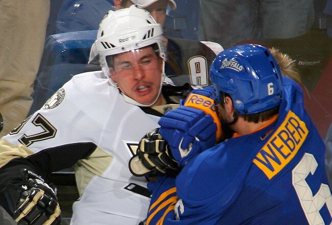 BUFFALO, NY - DECEMBER 11: Mike Weber #6 of the Buffalo Sabres checks Sidney Crosby #87 of the Pittsburgh Penguins at HSBC Arena on December 11, 2010 in Buffalo, New York.  (Photo by Rick Stewart/Getty Images)