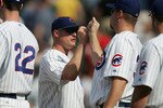 CHICAGO - JUNE 10:  Jeromy Burnitz #3 of the Chicago Cubs is congratulated by teammates Mark Prior #22 and Kerry Wood #34 after the Cubs defeated the Boston Red Sox 14-6 on June 10, 2005 at Wrigley Field in Chicago, Illinois.  (Photo by Jonathan Daniel/Getty Images)