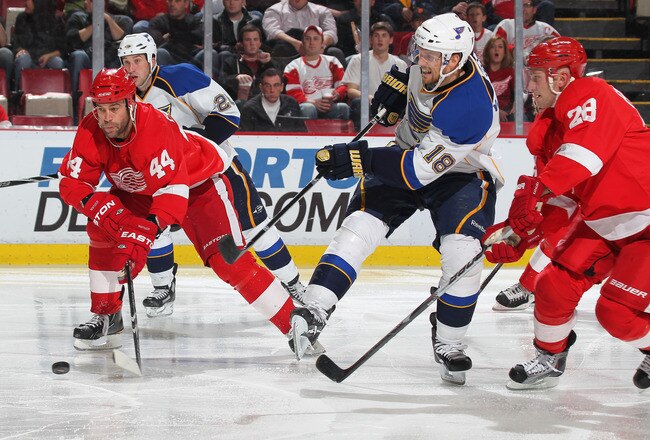 DETROIT, MI - NOVEMBER 17:  Todd Bertuzzi #44 of the Detroit Red Wings tries to keep the puck away from Jay McClement #18 of the St. Louis Blues in a game on November 17,2010 at the Joe Louis Arena in Detroit, Michigan. The Wings defeated the Blues 7-3. (Photo by Claus Andersen/Getty Images)