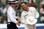 BANGALORE, INDIA - OCTOBER 12:  Umpire Billy Bowden and Virender Sehwag (R) of India share a lighter moment during day four of the Second Test match between India and Australia at M.Chinnaswamy Stadium on October 12, 2010 in Bangalore, India.  (Photo by Pal Pillai/Getty Images)