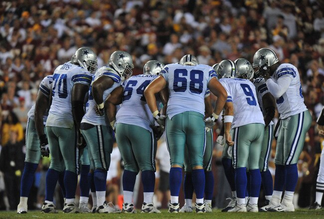 LANDOVER - SEPTEMBER 12:  The Dallas Cowboys offense huddles during the NFL season opener against the Washington Redskins at FedExField on September 12, 2010 in Landover, Maryland. The Redskins defeated the Cowboys 13-7. (Photo by Larry French/Getty Images)