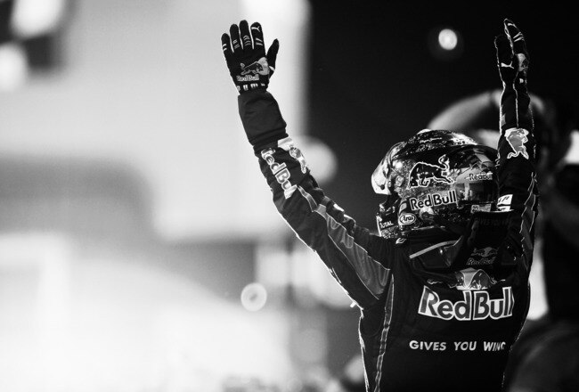 ABU DHABI, UNITED ARAB EMIRATES - NOVEMBER 14: (EDITORS NOTE: THIS BLACK AND WHITE IMAGE WAS CREATED FROM ORIGINAL COLOUR FILE)  Race winner and F1 2010 World Champion Sebastian Vettel of Germany and Red Bull Racing celebrates in parc ferme following the Abu Dhabi Formula One Grand Prix at the Yas Marina Circuit on November 14, 2010 in Abu Dhabi, United Arab Emirates.  (Photo by Ker Robertson/Getty Images)