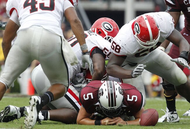 COLUMBIA, SC - SEPTEMBER 11: Quarterback Steven Garcia #5 of the South Carolina Gamecocks fumbles after being hit by defensive end Demarcus Dobbs #58 of the Georgia Bulldogs during the game at Williams-Brice Stadium on September 11, 2010 in Columbia, South Carolina. The Gamecocks beat the Bulldogs 17-6. (Photo by Mike Zarrilli/Getty Images)