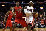 MIAMI - NOVEMBER 13:  Forward LeBron James #6 of the Miami Heat drives against Sonny Weems #24 of the Toronto Raptors at American Airlines Arena on November 13, 2010 in Miami, Florida. NOTE TO USER: User expressly acknowledges and agrees that, by downloading and or using this photograph, User is consenting to the terms and conditions of the Getty Images License Agreement.  (Photo by Marc Serota/Getty Images)