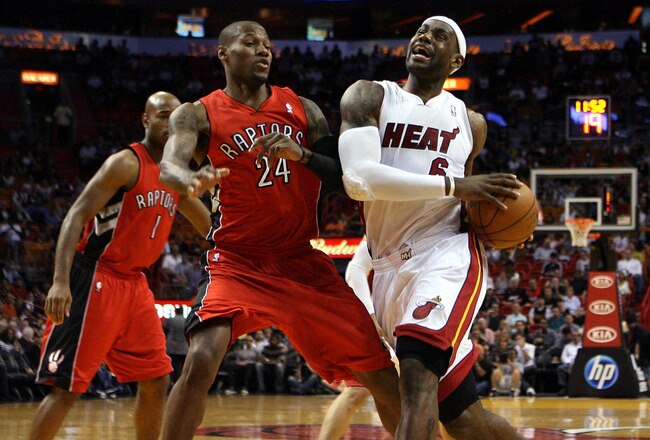 MIAMI - NOVEMBER 13:  Forward LeBron James #6 of the Miami Heat drives against Sonny Weems #24 of the Toronto Raptors at American Airlines Arena on November 13, 2010 in Miami, Florida. NOTE TO USER: User expressly acknowledges and agrees that, by downloading and or using this photograph, User is consenting to the terms and conditions of the Getty Images License Agreement.  (Photo by Marc Serota/Getty Images)