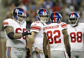 DETROIT, MI - DECEMBER 13: Eli Manning #10 of the New York Giants with teammates Dave Diehl #66 Mario Manningham #82 and Hakeem Nicks #88 during the game against the Minnesota Vikings at Ford Field on December 13, 2010 in Detroit, Michigan.  (Photo by Leon Halip/Getty Images)