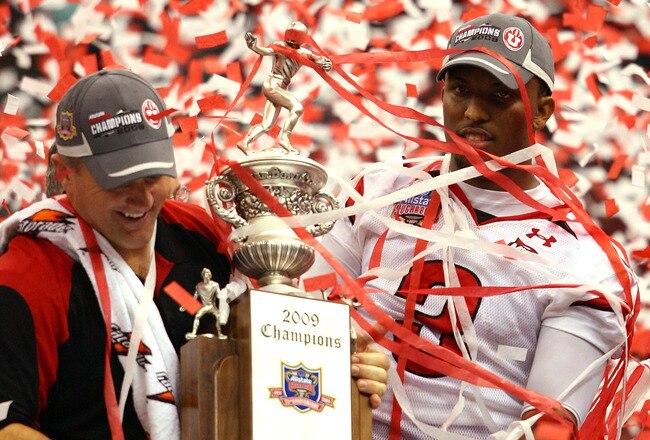 NEW ORLEANS - JANUARY 02:  Head coach Kyle Whittingham and quarterback Brian Johnson #3 of the Utah Utes celebrates after defeating the Alabama Crimson Tide 31-17 during the 75th Allstate Sugar Bowl at the Louisiana Superdome on January 2, 2009 in New Orleans, Louisiana.  (Photo by Matthew Stockman/Getty Images)